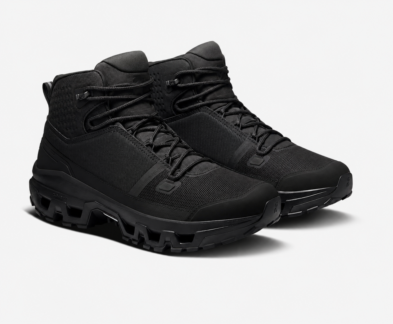 All-black mid-cut hiking boot on a lugged outsole